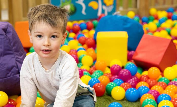 Ball pit with boy
